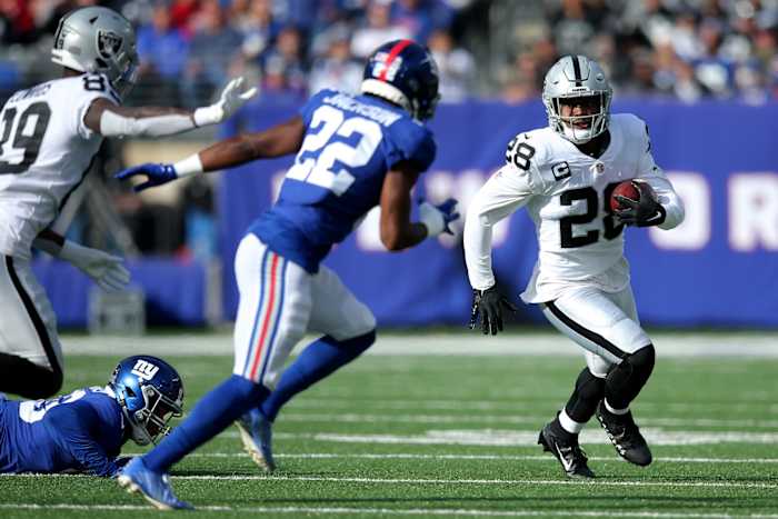Nov 7, 2021; East Rutherford, New Jersey, USA; Las Vegas Raiders running back Josh Jacobs (28) runs the ball against New York Giants cornerback Adoree' Jackson (22) during the first quarter at MetLife Stadium.